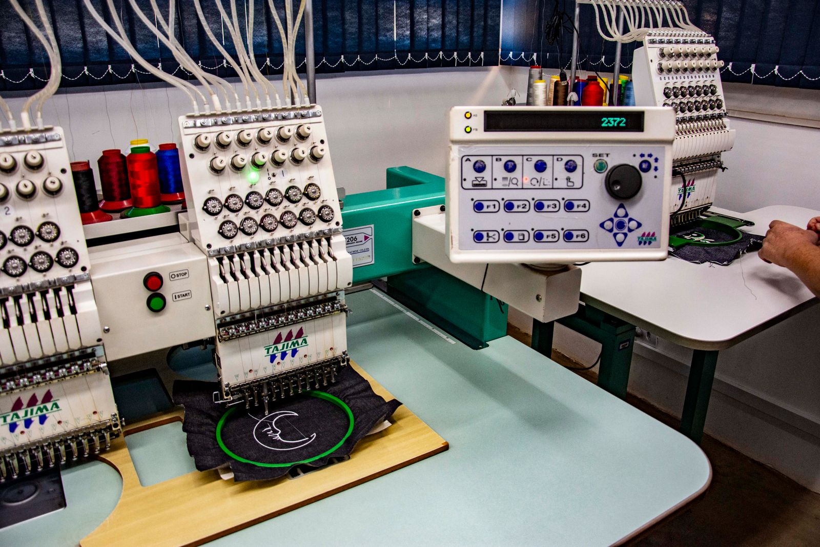 Multi-head embroidery machines running garments