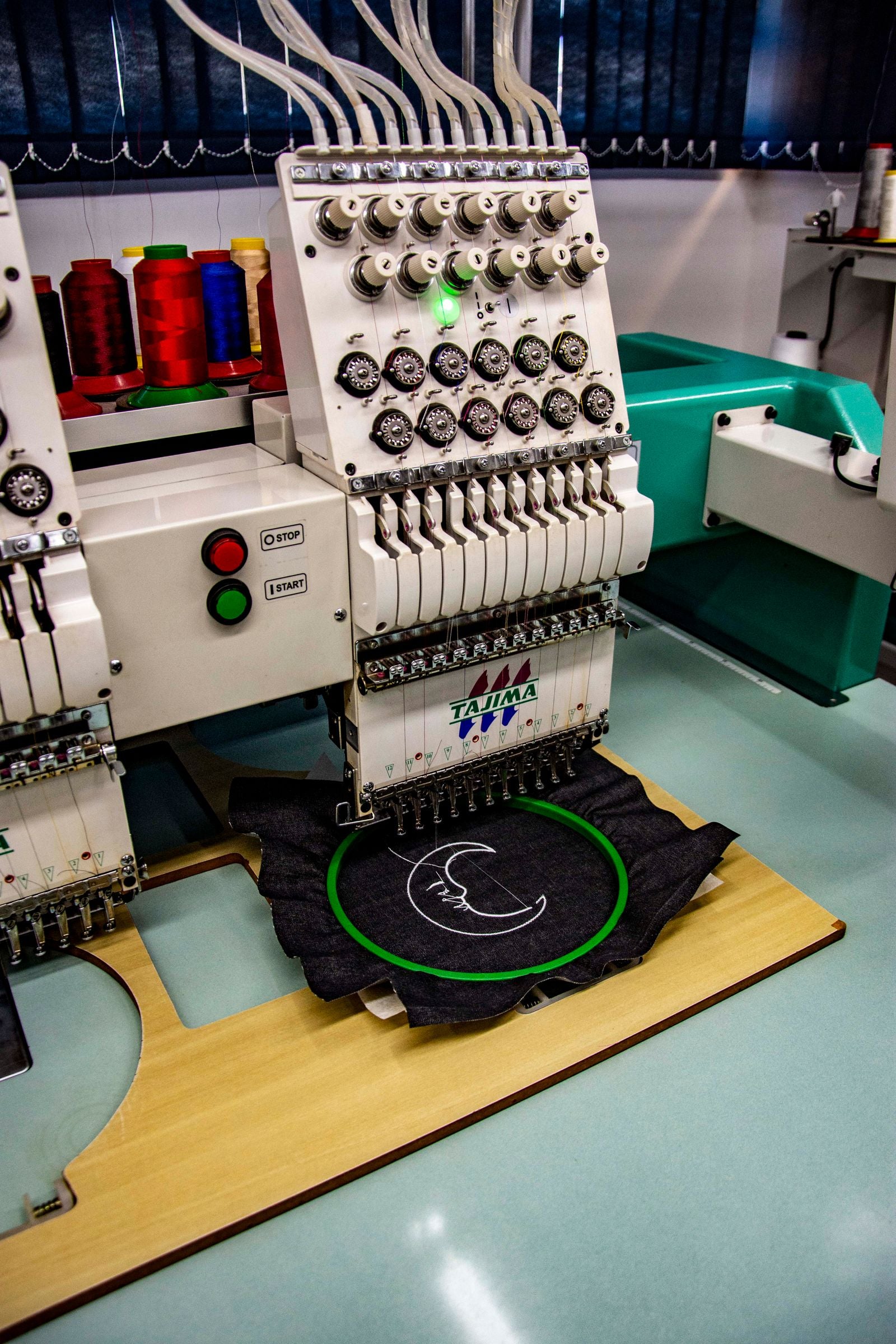Embroidery machine stitching a design into fabric