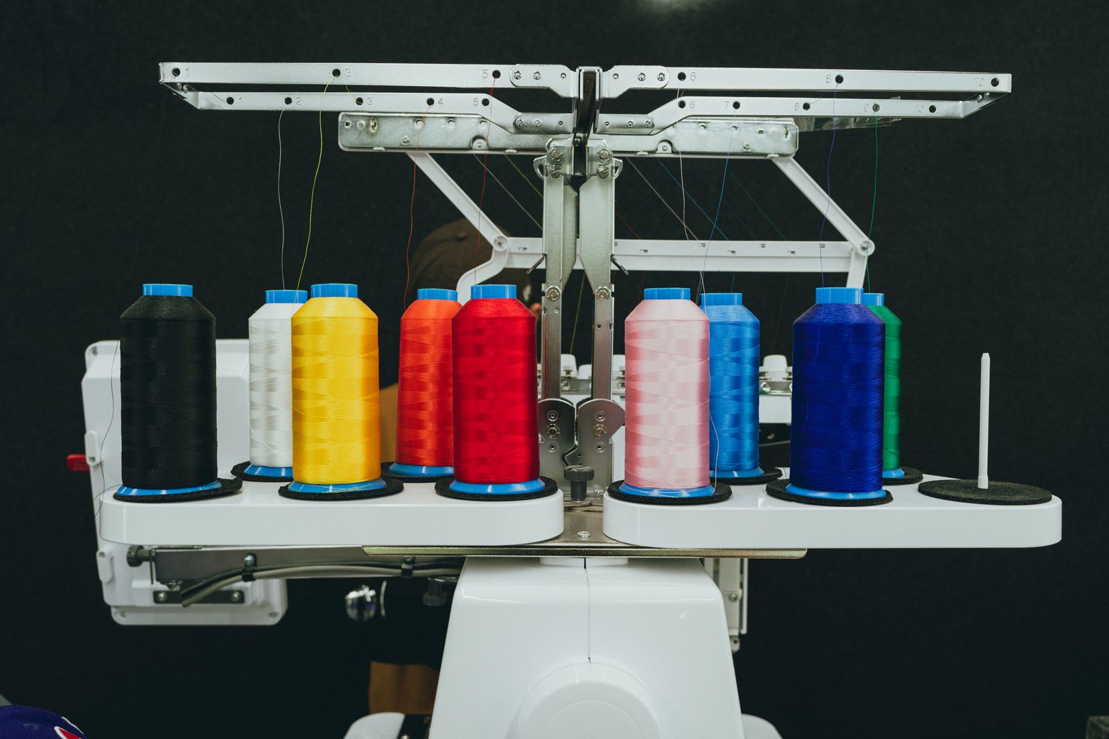 Coloured thread cones on an embroidery machine